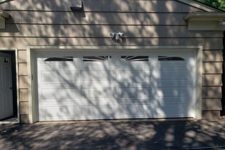 Exterior view of a home in Emerson, GA with a newly installed white garage door and upgraded Chamberlain automatic opener.
